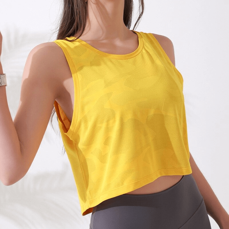Woman wearing a yellow camouflage running tank, breathable crop top for fitness and sports activities.